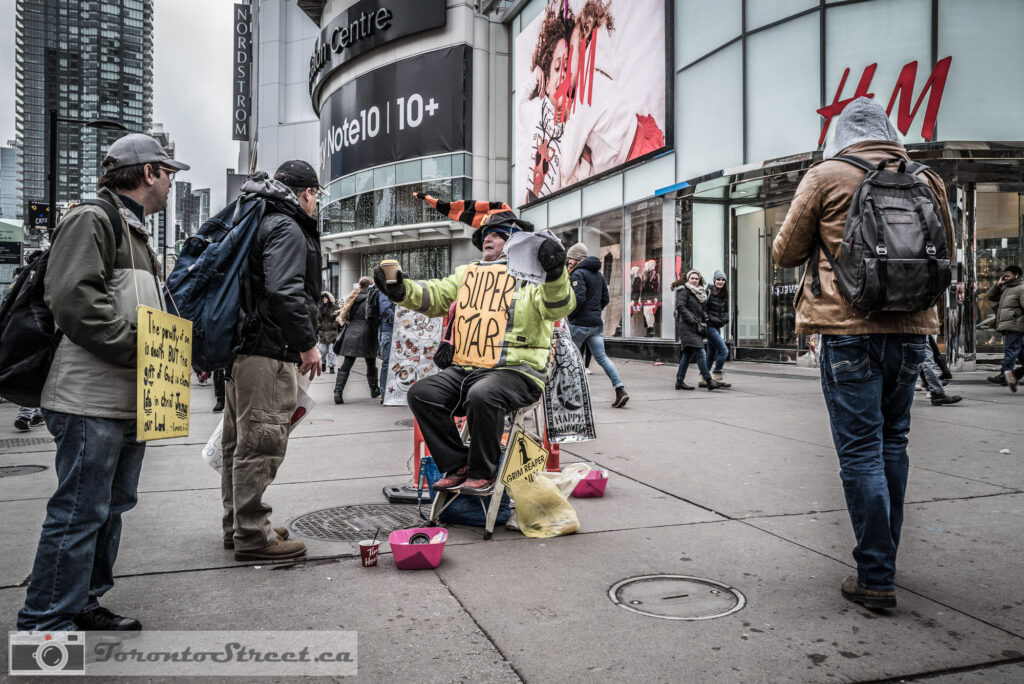 Super Star street performer on skateboard at Yonge-Dundas Square gathers a crowd gathered, Fuji X100V