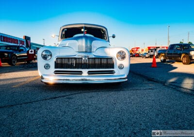 White coupe rim-lit by the setting sun, bright edges against the pavement, Richmond Hill, Leica Q3