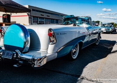Top-down Bel Air convertible from the rear, body-colour continental kit and chrome bumper, Canadian Tire plaza, Leica Q3
