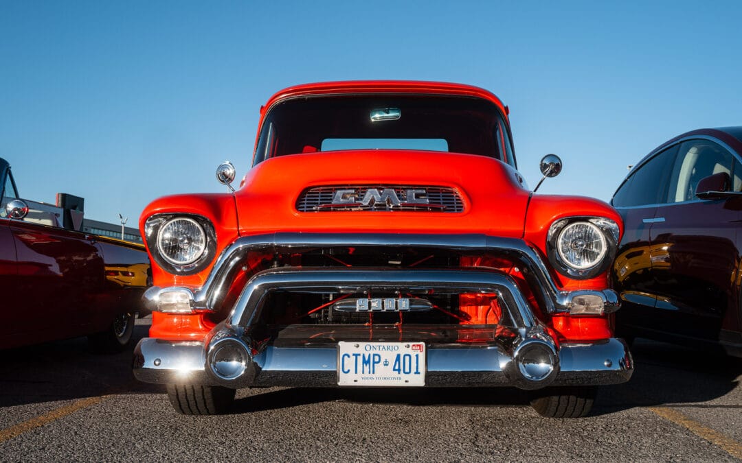 Orange 1957 GMC 9300 Stepside parked front three-quarter at a Richmond Hill cruise night, Leica Q3