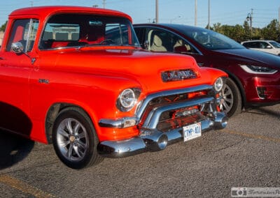 Front three-quarter of the orange pickup, chrome bull bar catching the low sun, Richmond Hill, Leica Q3