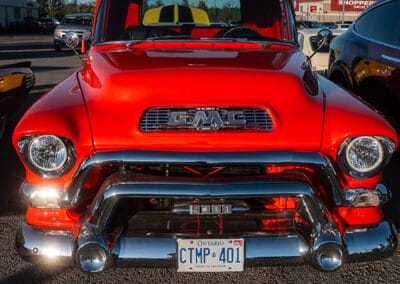 Chrome grille and hooded single headlights of a GMC 9300 Stepside at dusk, Leica Q3