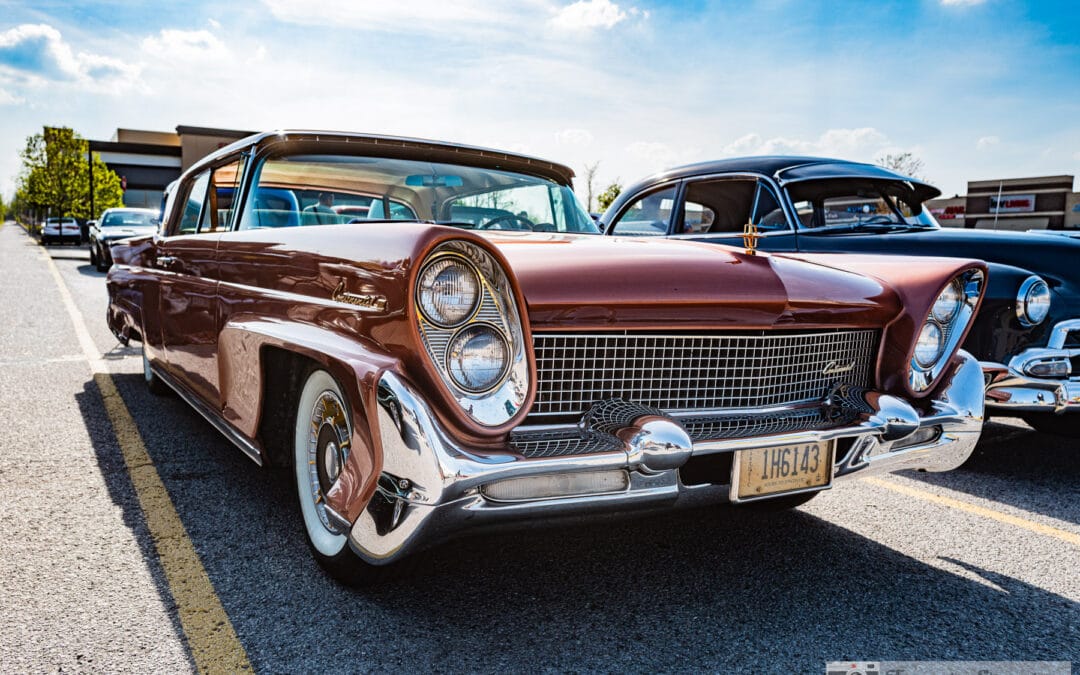 1958 Lincoln Continental Mark III in copper, canted quad headlights and a wide chrome grille under a blue sky, Leica Q3