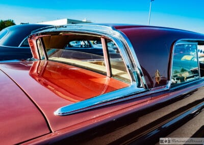 Rear of a 1958 Lincoln Continental Mark III, reverse-slant breezeway window and wide deck among classics at dusk, Leica Q3