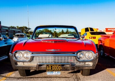 Head-on grille and Thunderbird emblem of the red 1961 convertible, Leica Q3