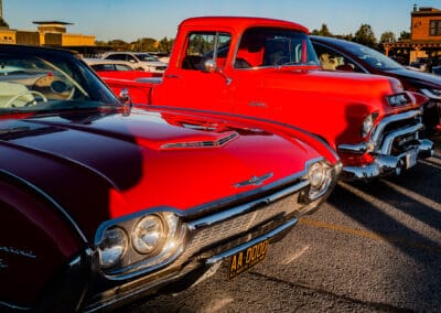 Front fender and chrome detail of the red car beside a black coupe, Leica Q3