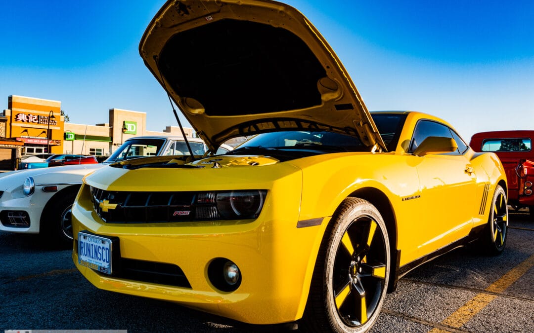 Front three-quarter of the Bumblebee-striped yellow coupe, HID halo headlights and twenty inch wheels, Leica Q3
