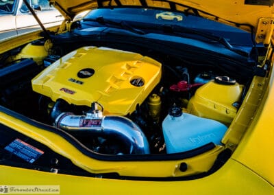 The 3.6 litre LFX V6 engine bay with yellow cover and blue accents, Leica Q3