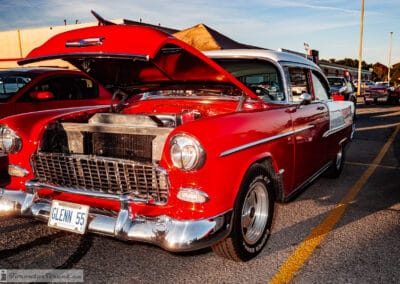 Red two-tone hardtop, hood open over the motor, egg-crate grille and GLENN 55 plate, Richmond Hill, Leica Q3