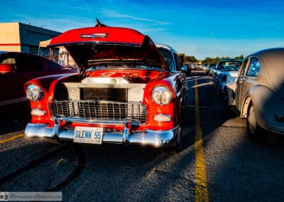 Head-on 1955 Chevrolet Bel Air with the hood raised over the engine, GLENN 55 plate, low sun, Leica Q3