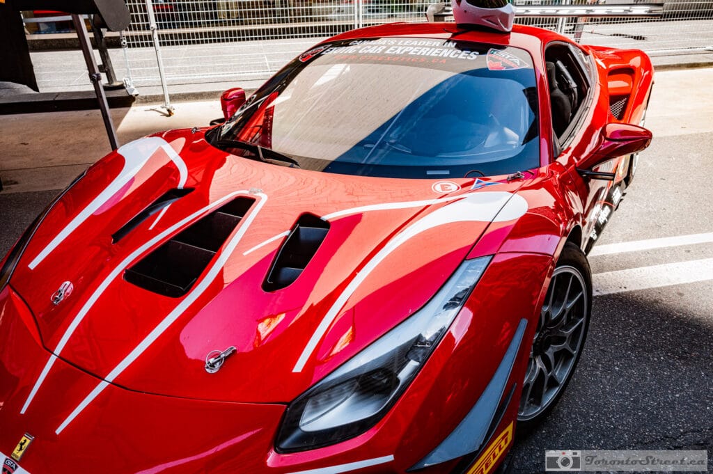 Ferrari 488 Challenge Evo---2 Ferrari 488 Challenge Evo in the staging area, prancing horse badge and racing slicks, Leica Q3