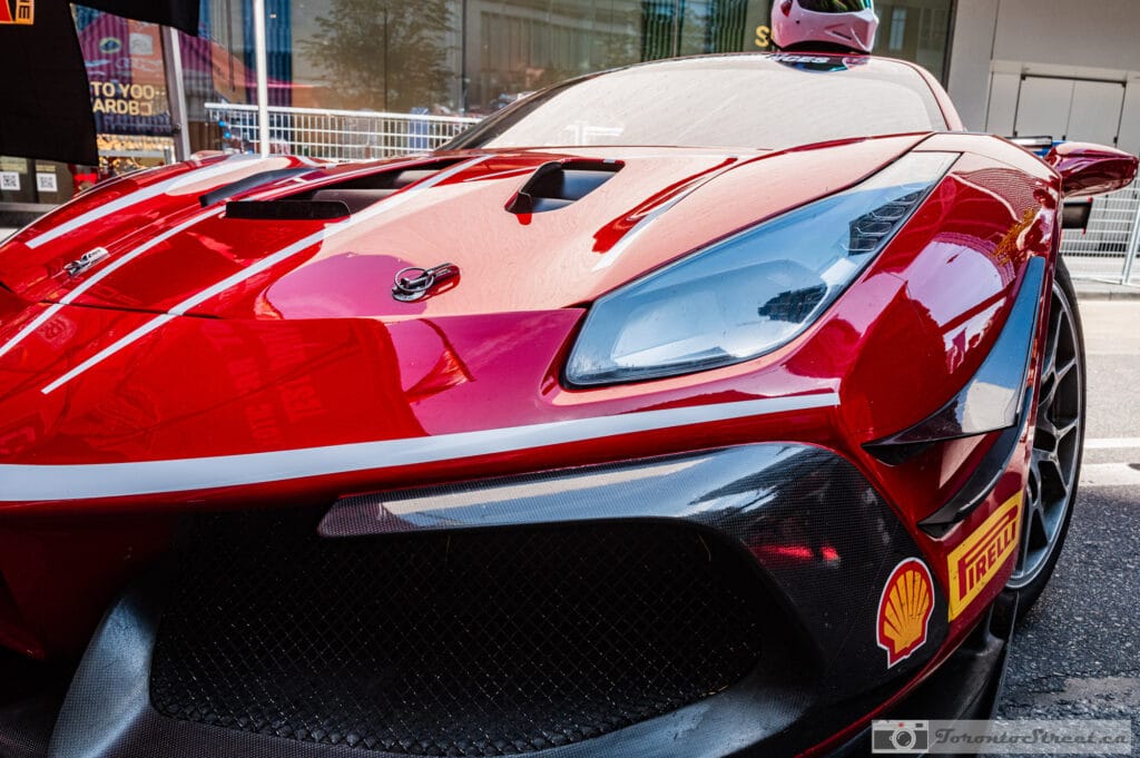 Ferrari 488 Challenge Evo,_- Ferrari 488 Challenge Evo front detail, white stripes over the vented hood and a Shell decal, Leica Q3