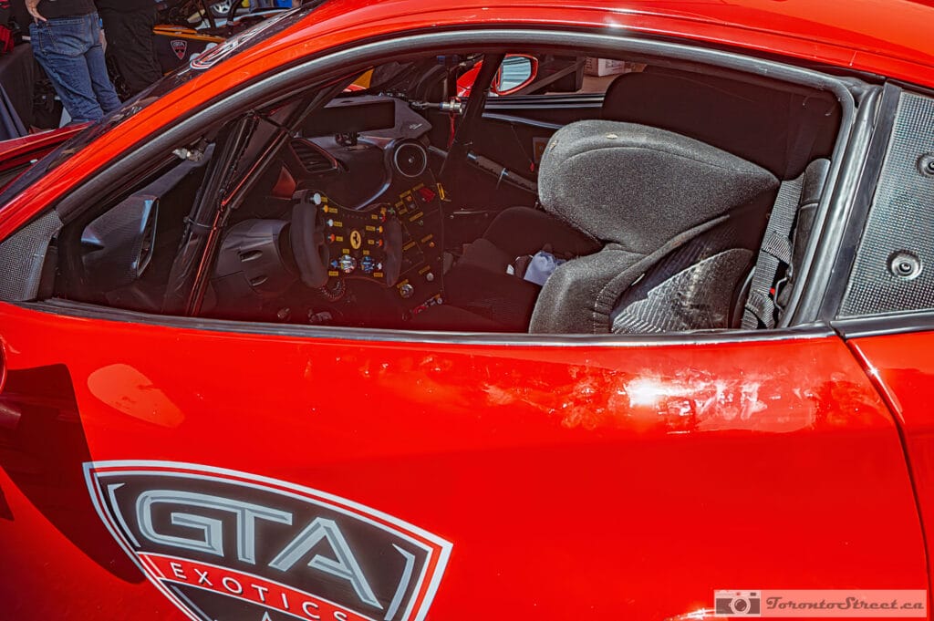 Ferrari 488 Challenge Evo,_-1000876-Edit Stripped racing cockpit of a Ferrari 488 Challenge Evo, bare cage and carbon seat behind the side glass, Leica Q3