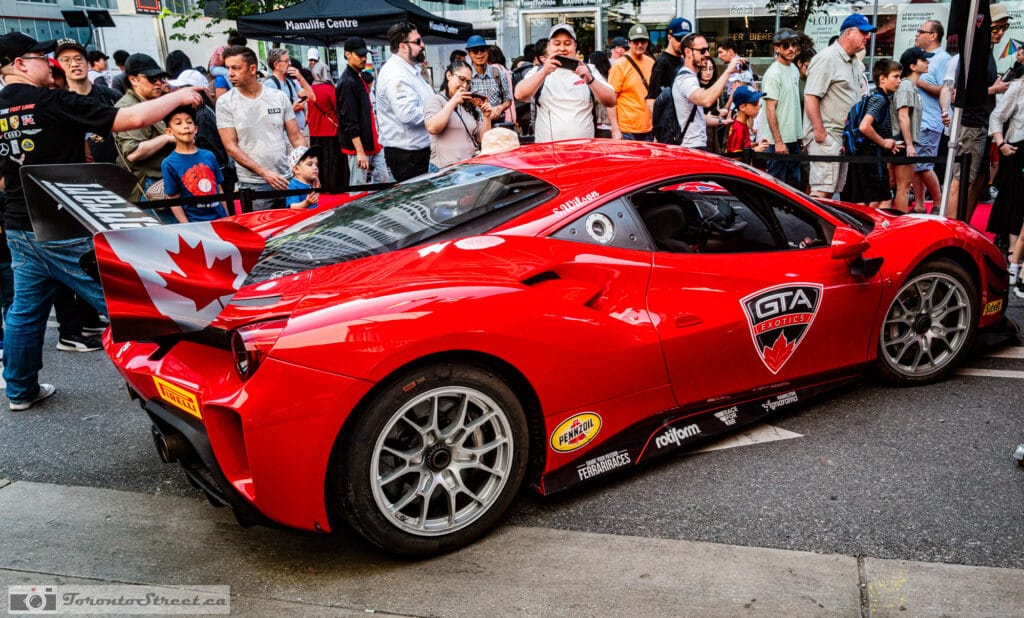 Ferrari 488 Challenge Evo,_-1000981 Ferrari rear wing with a Canadian maple leaf, crowd and the LCBO sign on Bloor Street, Leica Q3