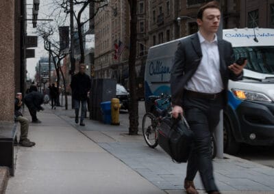 Man in a suit striding along Bay Street checking his phone, briefcase in hand, toronto street photography interesting people, Leica Q2