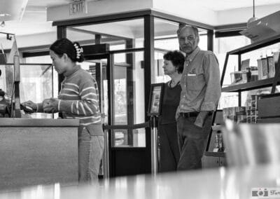Black and white, a couple waiting at the Tim Hortons counter to order, tim hortons street photography, Leica Q3