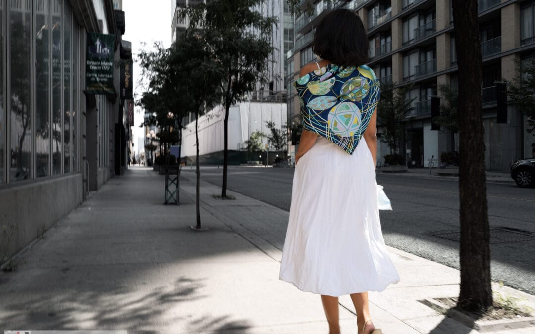Woman in a flowing white skirt walking a quiet downtown street, shot from behind, toronto street photography interesting people, Leica Q2