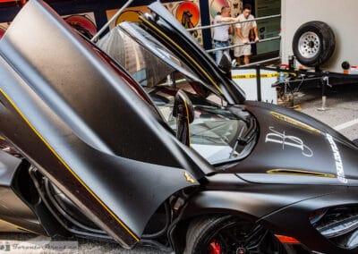 Raised supercar door in satin finish over a low cockpit, Yorkville show, Leica Q3