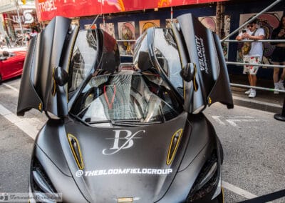 McLaren 720S with both butterfly doors raised on Bloor Street, Yorkville crowd, Leica Q3