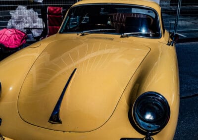 Curved hood and single headlight of a vintage coupe seen from above, Yorkville, Leica Q3
