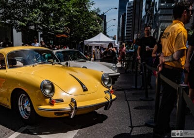 Yellow Porsche 356 beside a silver sister car on Bloor Street, Yorkville crowd, Leica Q3