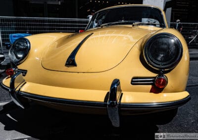 Round headlights and chrome bumper overriders on a classic coupe at the Yorkville show, Leica Q3