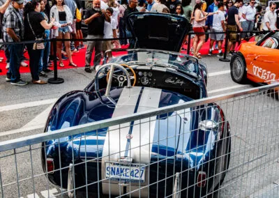 Rear of a Shelby Cobra with the SNAKE 427 Ontario plate and racing stripes, Yorkville crowd, Leica Q3