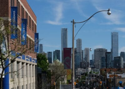 Spadina Avenue looking south toward the downtown skyline, elderly woman and companion walking, toronto sunday street photography, Fuji X100V