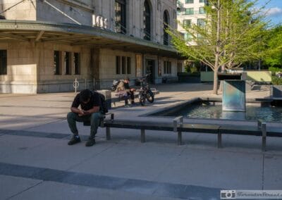 Man at the Summerhill LCBO fountain absorbed in his phone, a quiet Toronto Sunday afternoon, Fuji X100V