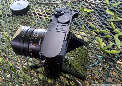 Leica Q3 with its tilting rear screen flipped out reflecting the trees, 28mm Summilux lens, Galaxy Z Fold7