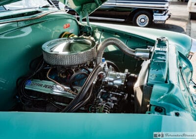Chrome air cleaner and Mopar Performance valve cover in a green engine bay, Leica Q3