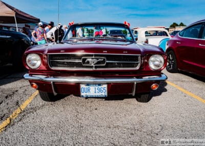 Head on view of the Mustang grille and running horse emblem in its chrome corral, Leica Q3