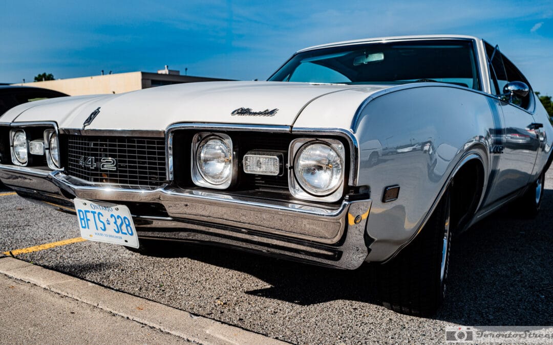 1968 Oldsmobile 442 Holiday Coupe in white, front three quarter view at a Richmond Hill cruise night, Leica Q3