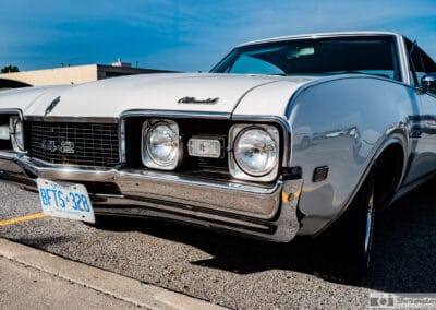 1968 Oldsmobile 442 Holiday Coupe in white, front three quarter view at a Richmond Hill cruise night, Leica Q3