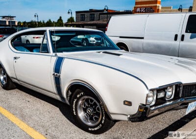 Side profile of the white 1968 hardtop, blue rocker stripe and Cooper white letter tires, Leica Q3