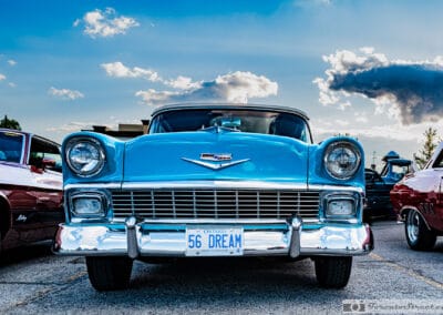 Head on at a Monday cruise night, the full width grille and 56 DREAM plate of a 1956 Bel Air, Toronto, Leica Q3