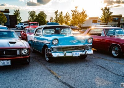 Three classics in a row at sunset, a Mustang, a turquoise Chevrolet drop-top and a maroon coupe, Leica Q3