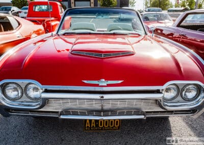 Head-on of a red 1961 Thunderbird convertible, top down, quad headlights and hood scoop, north of Toronto, Leica Q3