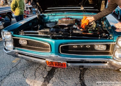 Owner wiping down the 389 V8 of a 1966 GTO convertible with an orange cloth, Monday cruise night, Richmond Hill, Leica Q3