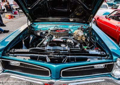 Looking down into the 389 V8 engine bay of a 1966 GTO, chrome air cleaner against a turquoise block, Richmond Hill, Leica Q3
