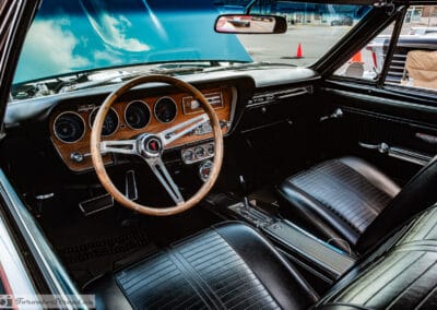 Black bucket seats and wood grain dash of a 1966 GTO convertible, extra gauges under the dash, Richmond Hill, Leica Q3