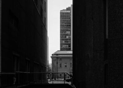 Black and white street geometry, an empty ramp between two dark downtown towers, Toronto, Leica Q3